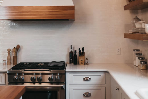 A classy white kitchen with wood in Brossard  - TBL Construction